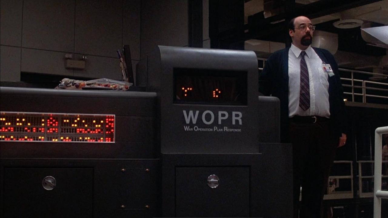 Irving-Metzman-as-Richter-standing-next-to-the-WOPR-War-Operations-Plan-Response.jpg
